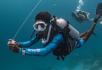 A diver holding a dsmb reel