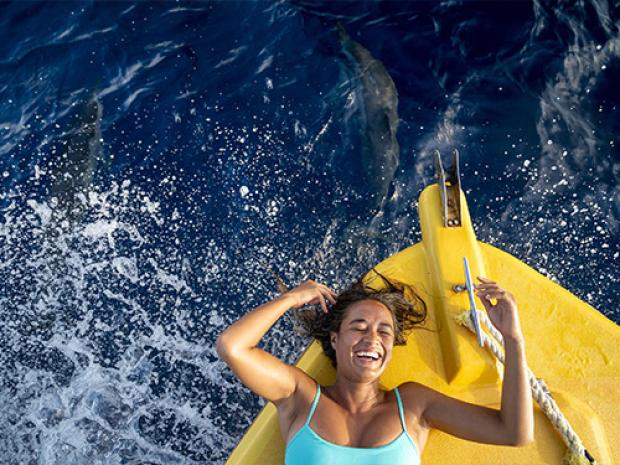 Person smiling near topside boat bow