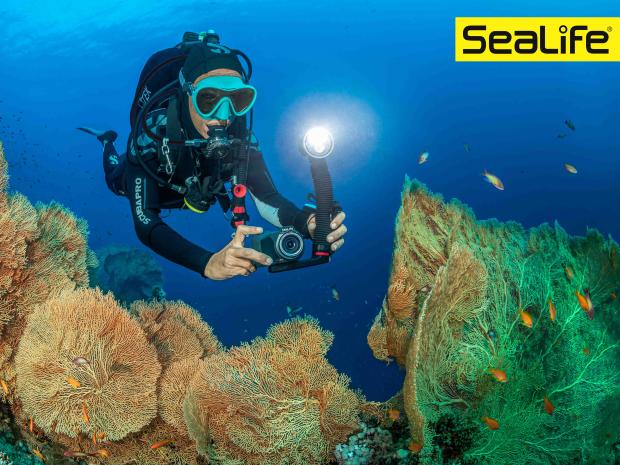 diver swimming with a product from sealife