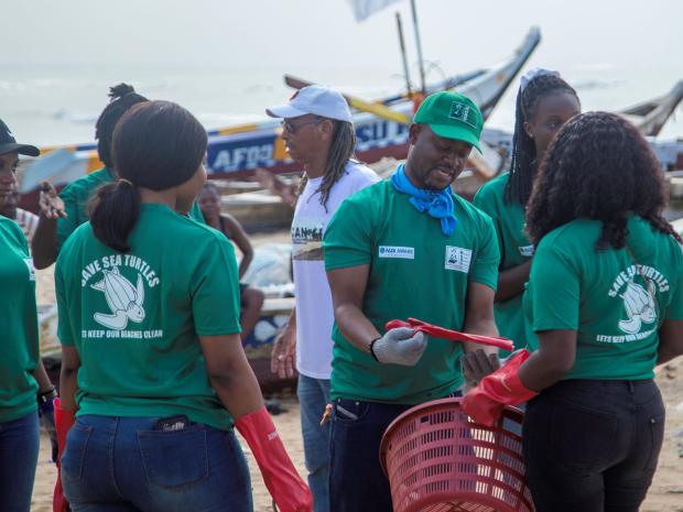 WHRO Beach Cleanup_ Andrews Agyekumhene (green cap) explaining the process before the exercise