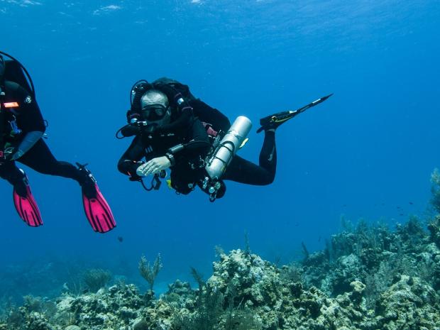 Diver with rebreather and emergency tank