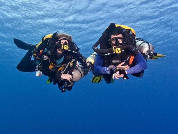 two divers with rebreathers