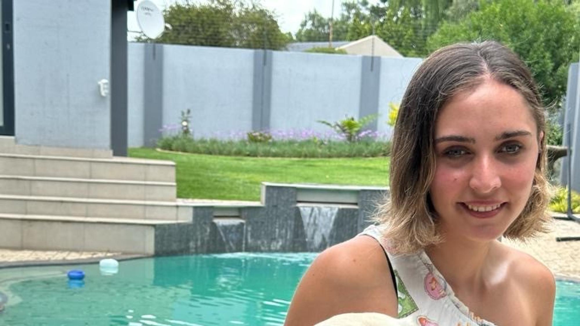 PADI Ambassadiver Jessica Pita sitting for a photo with her dog.